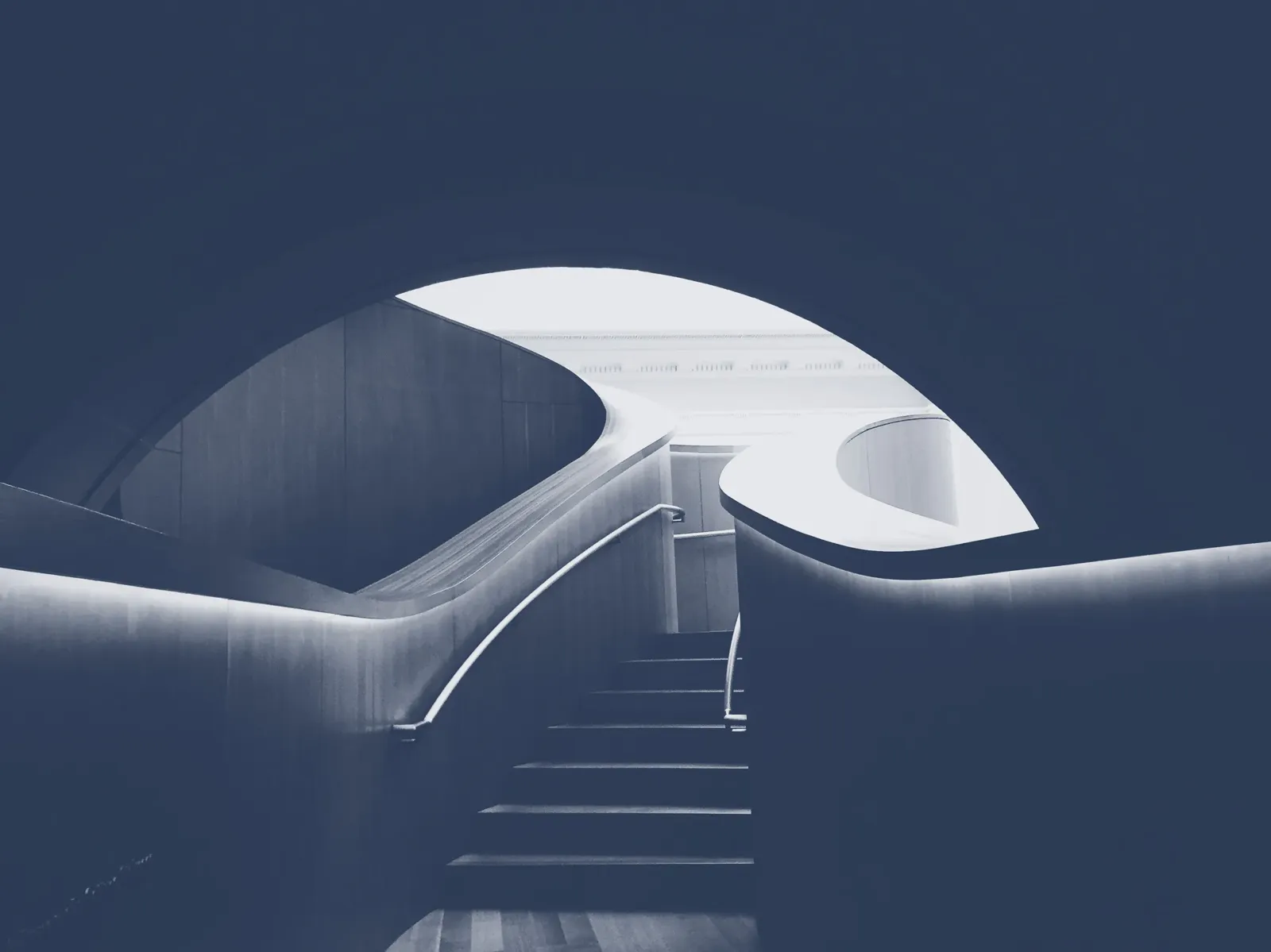 Curved staircase in a modern building, night blue duotone